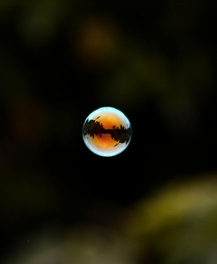 Abstract glowing turquoise sphere on dark background